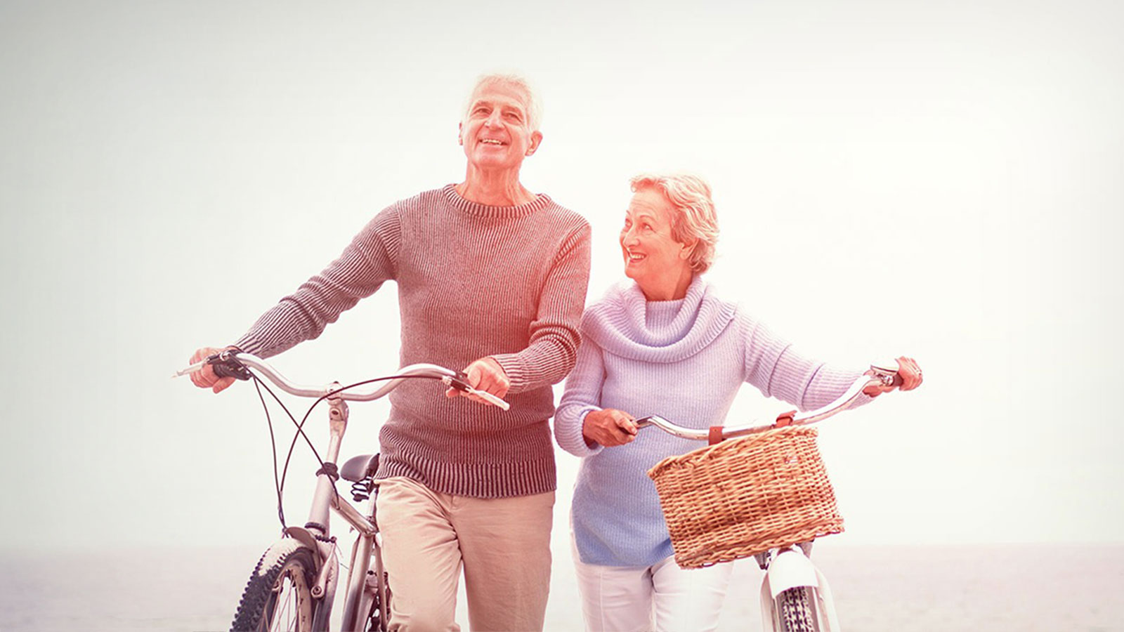 opri-hero-couple-with-bikes-beach
